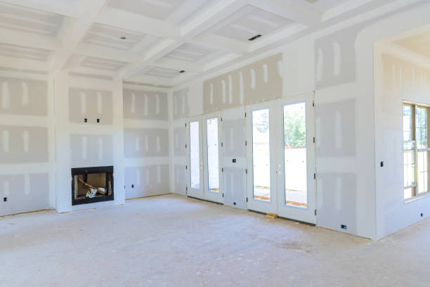 Plastering drywall in preparation for painting in newly constructed house
